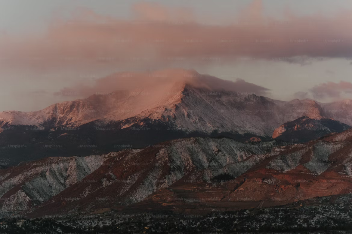 Hiker reaching a snowy peak